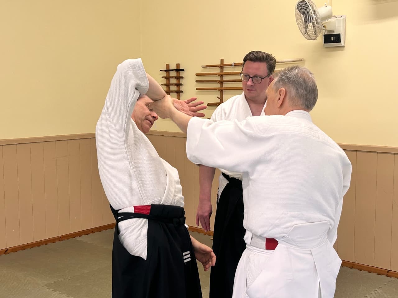 Sensei demonstrating how that grip, held correctly, can take the partner's balance.